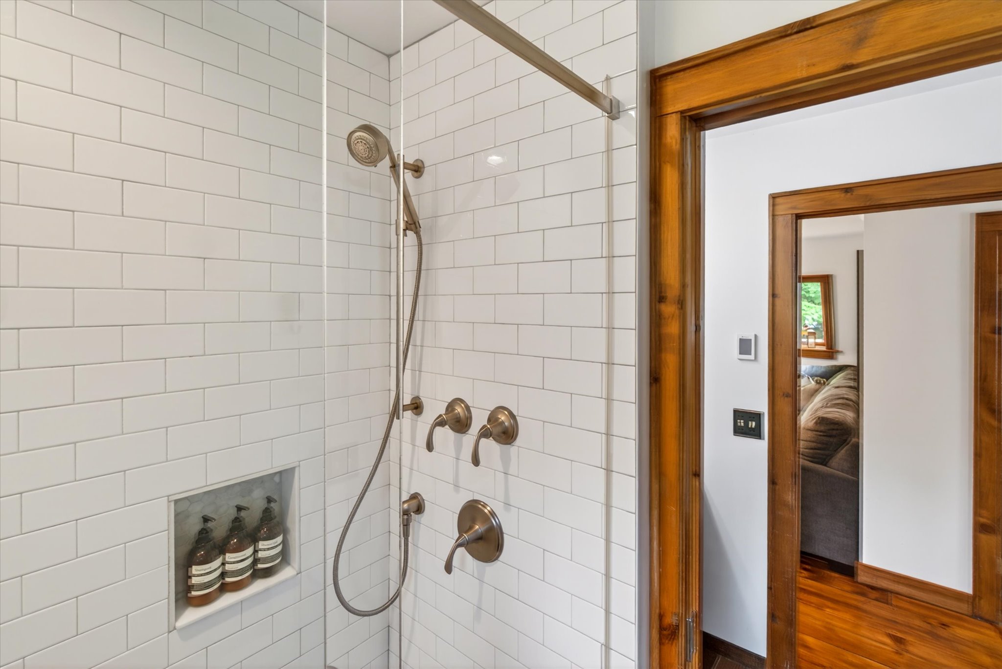 Upper shower — subway tile, bronze fixtures, and premium bath and body collection — Slippery Slope Chalet