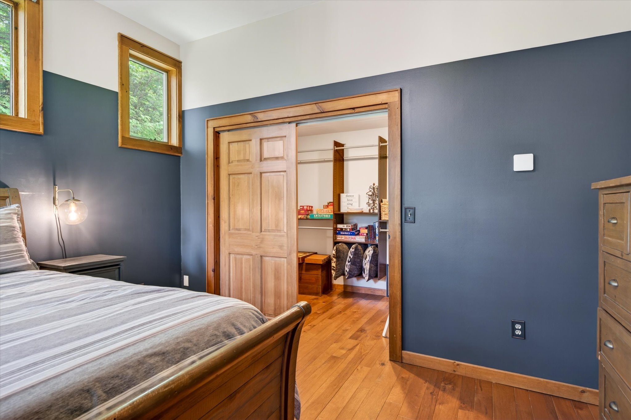 Blue Square Bedroom walk-in closet with board game storage — Slippery Slope Chalet