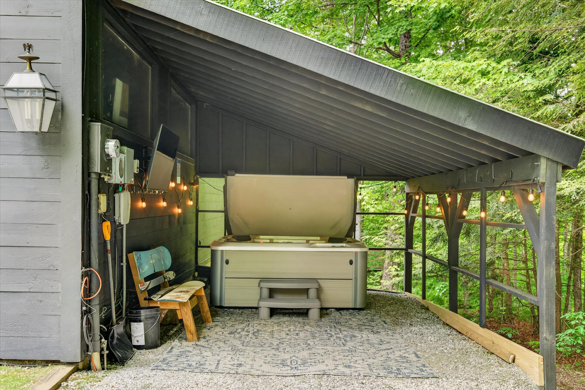 Covered hot tub shelter exterior with string lights — Slippery Slope Chalet