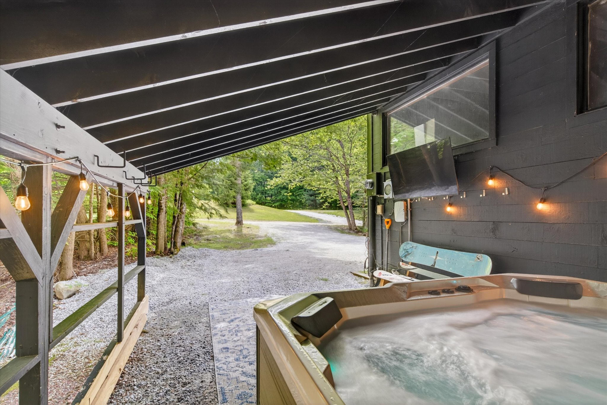 Hot tub open and bubbling with Vermont forest view — Slippery Slope Chalet